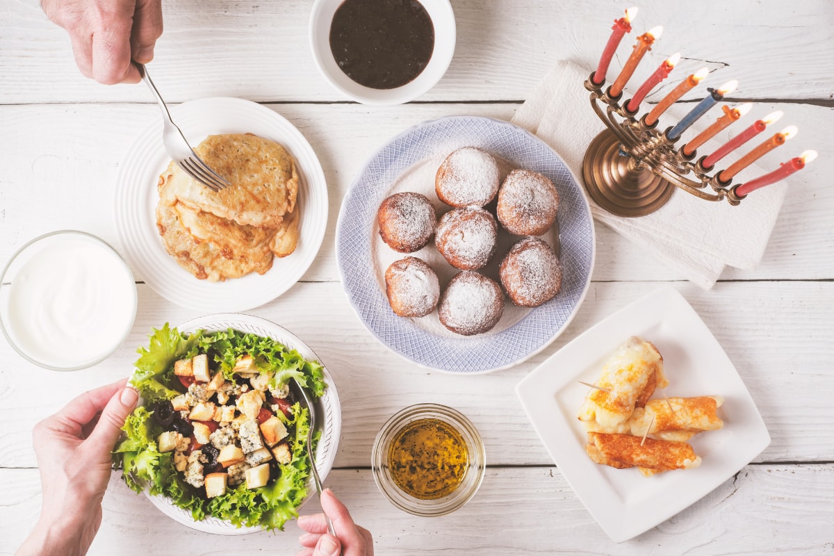 hanukkah table with food and a menorah