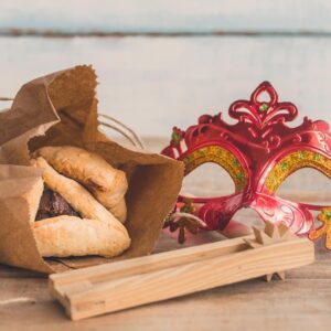 Purim Items: Hamantaschen (Oznei Haman), Purim masks, and Gragger (traditional noise maker)