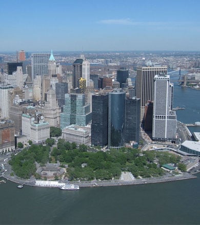 birds-eye view of park in new york with skyscrapers behind it