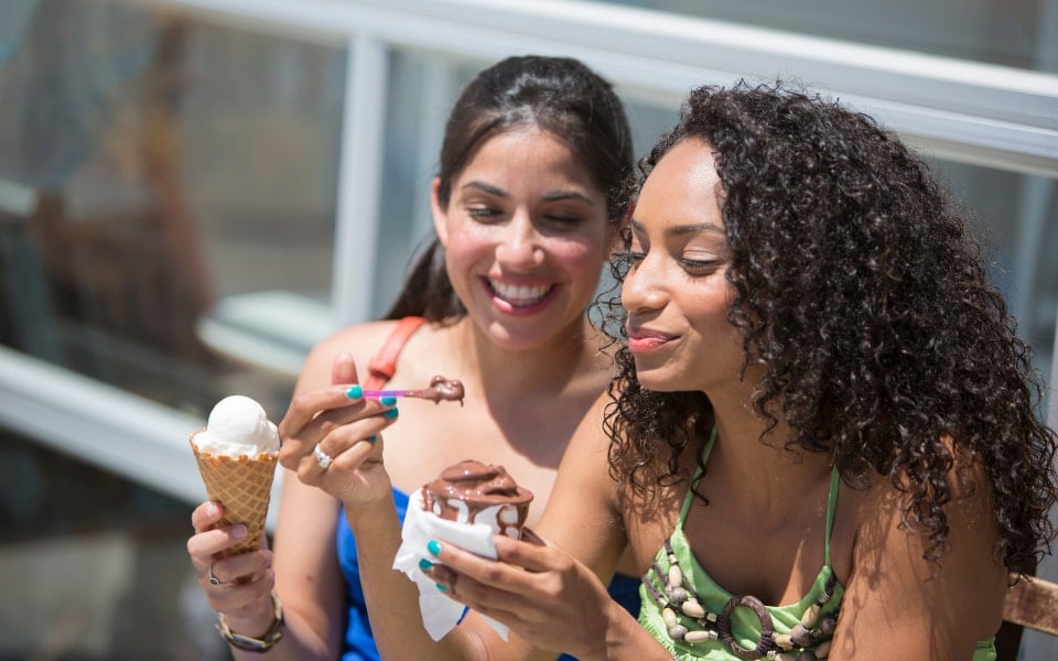 two girls eating ice cream outside