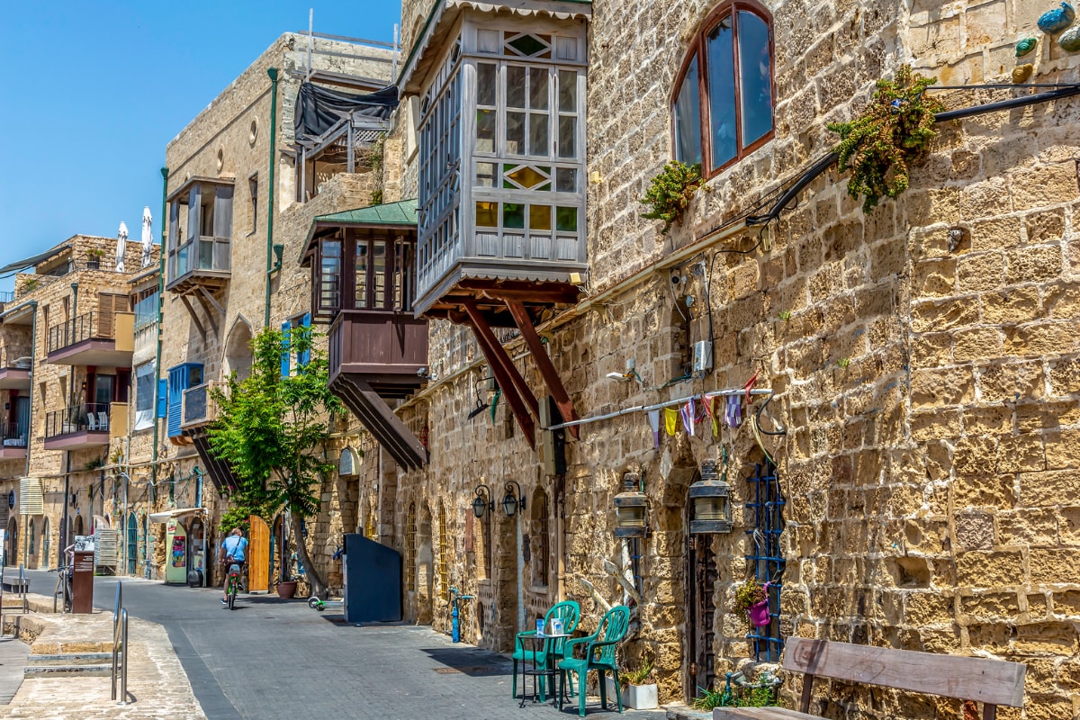 historic stone buildings in the old city of jaffa with a pedestrian path 