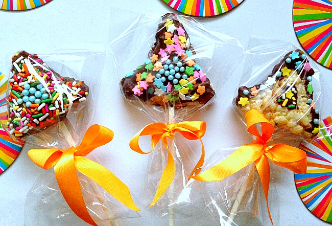 Hamantaschen made out of rice krispy treats on a stick with sprinkles